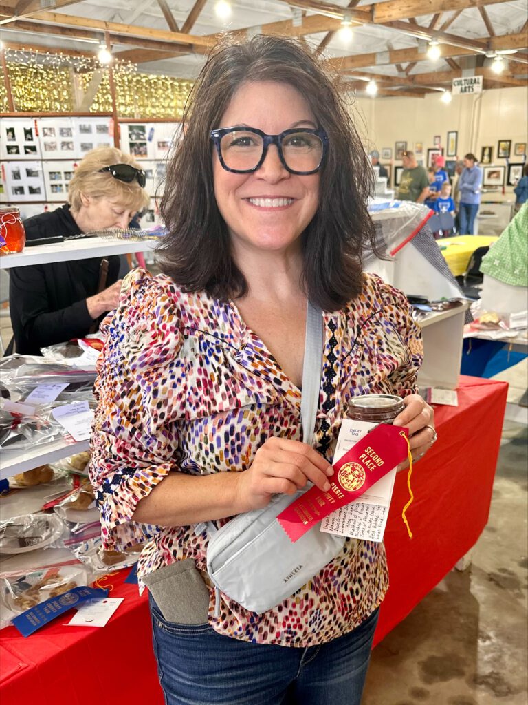 Shannon at the Pierce County Fair with red ribbon and strawberry rhubarb jam