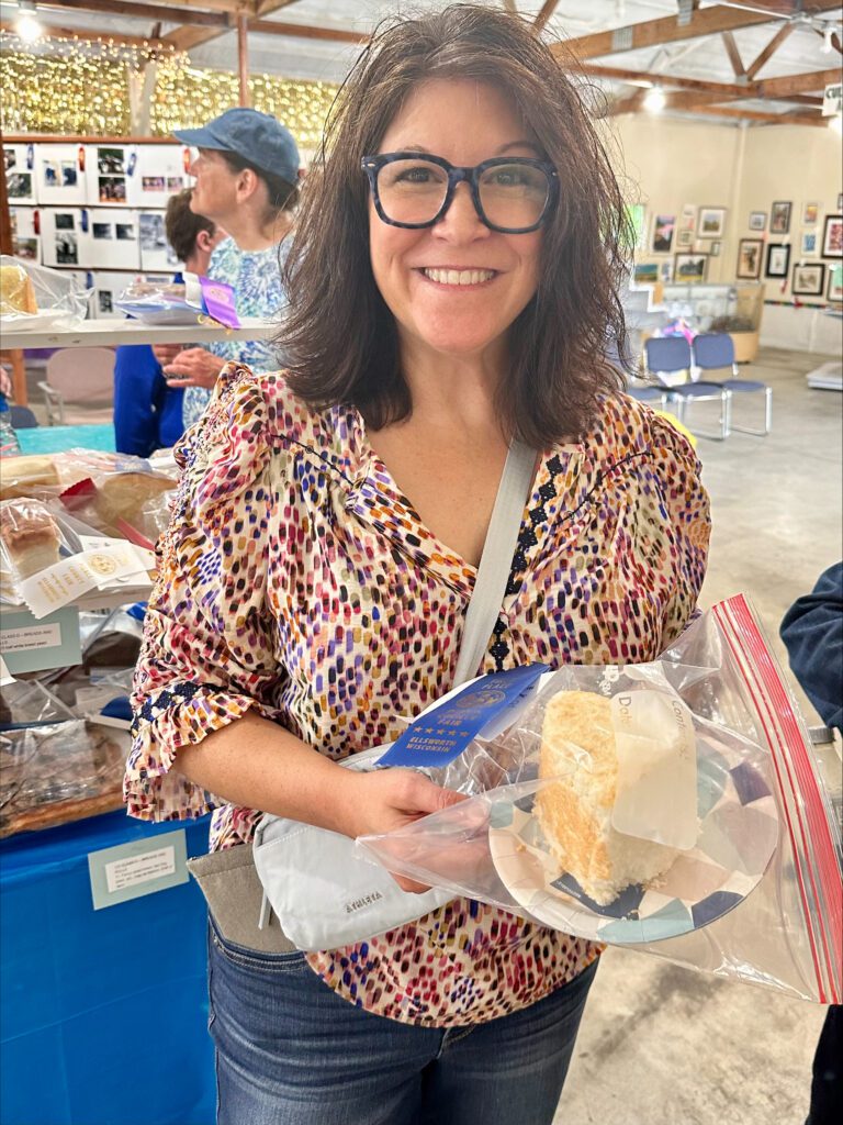 Shannon at the Pierce County Fair with blue ribbon and angel food cake