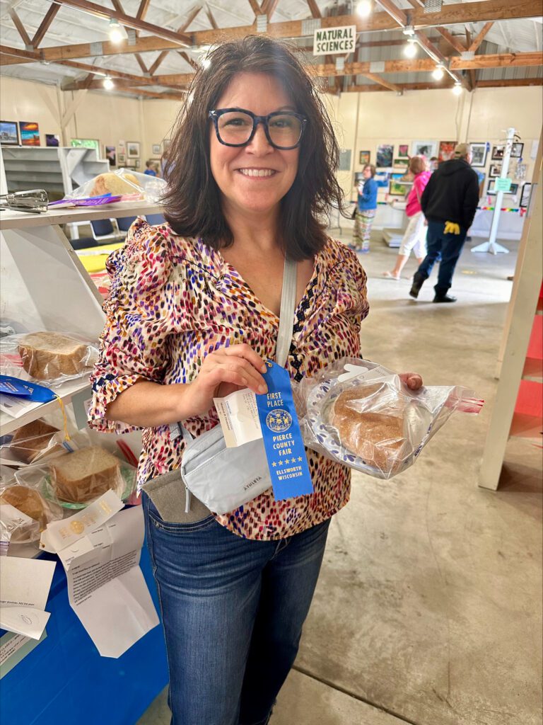 Shannon at the Pierce County Fair with blue ribbon and sourdough bread