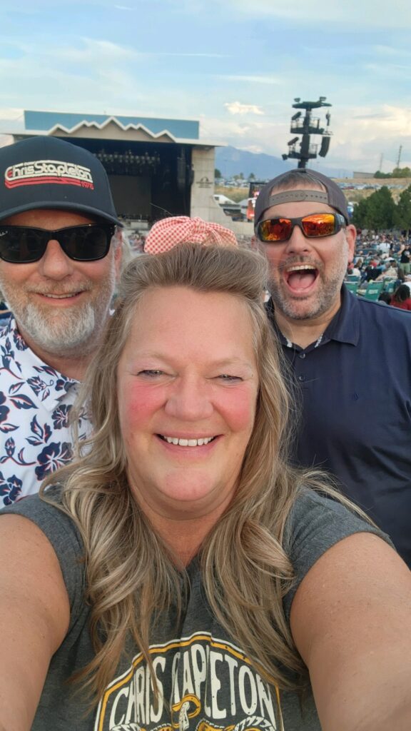 three people at an outdoor concert