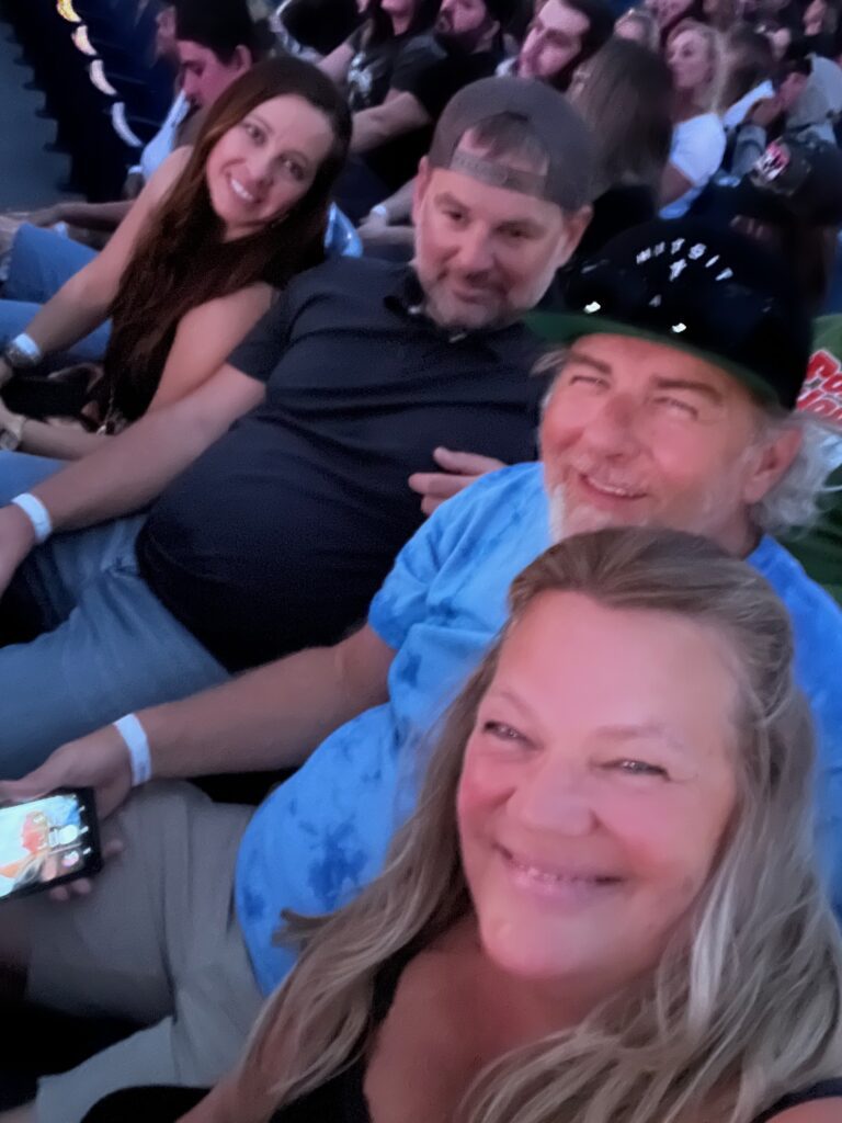 four people at an outdoor concert