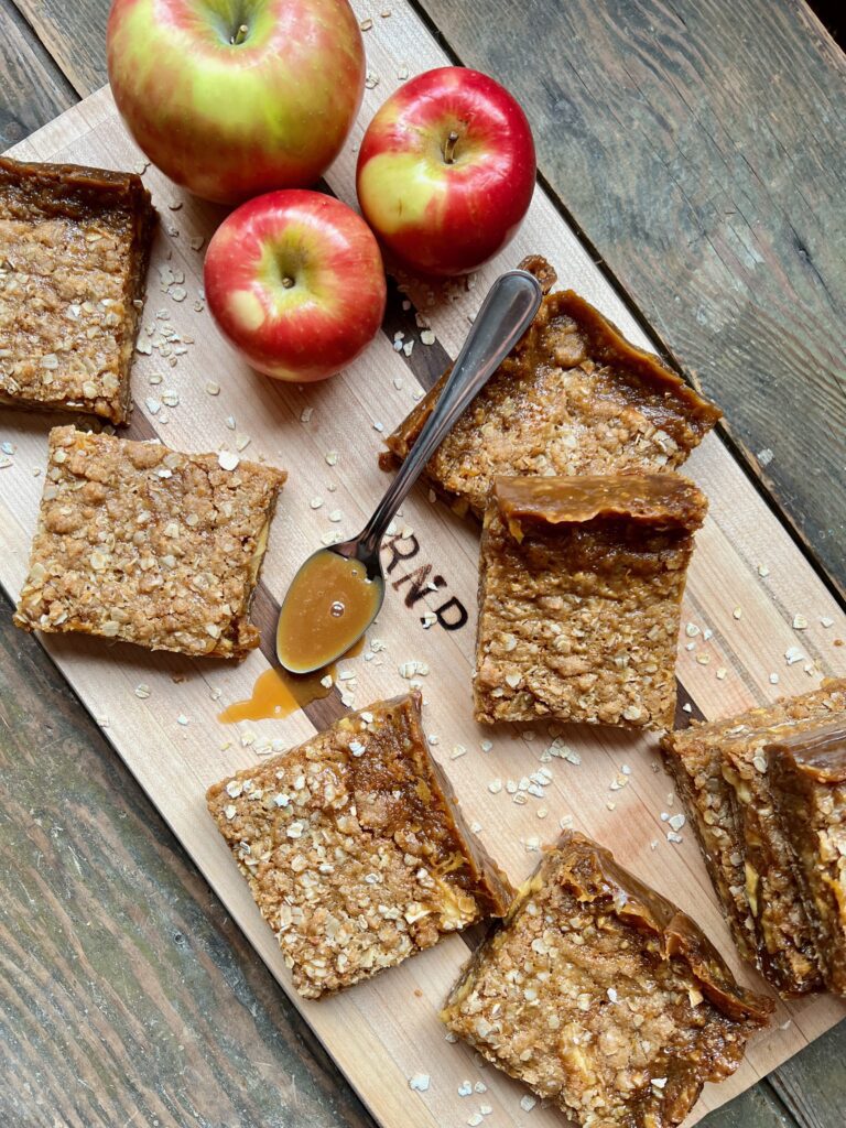 butterscotch caramel apple bars and apples on cutting board