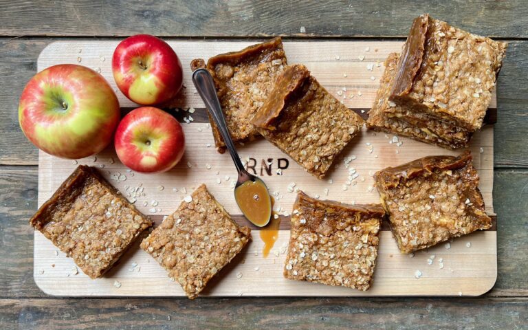 butterscotch caramel apple bars and apples on cutting board