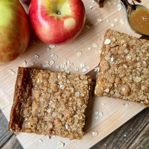 butterscotch caramel apple bars and apples on cutting board